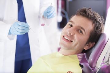 Patient smiling in chair at dentist in Arlington WA