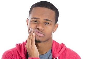 man holding jaw from toothache