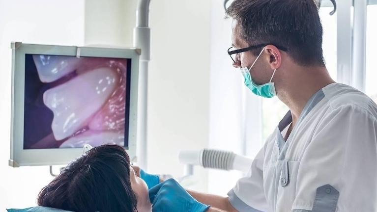 man checking a dental image