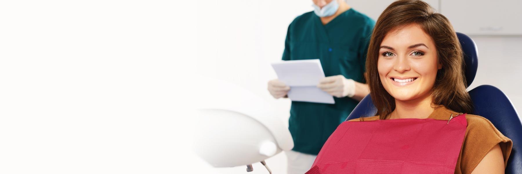 Woman smiling at emergency dentist in Arlington WA