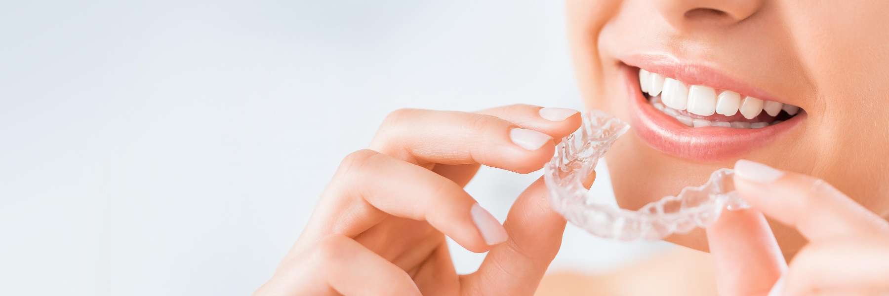 woman holding invisalign