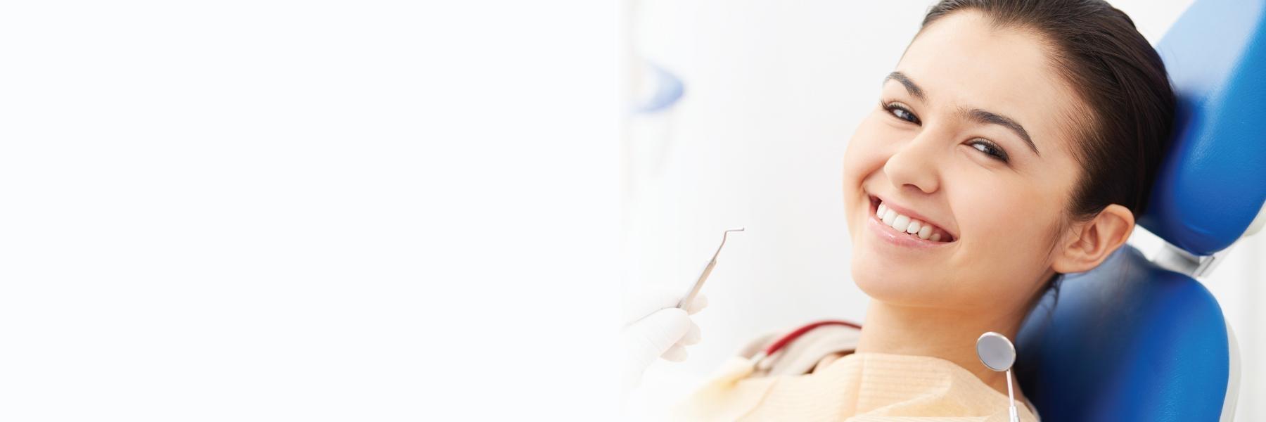 Woman smiling in chair at dentist in Smokey Point WA